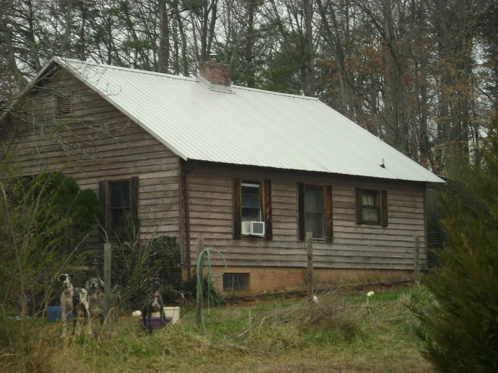 White metal roof on an old wood sided farmhouse, from a Metal Roof Installation job in Malverne